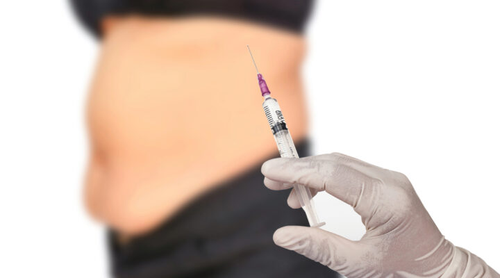 syringe with a woman in the background
